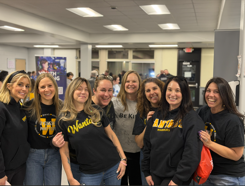 women in a cafeteria smiling together